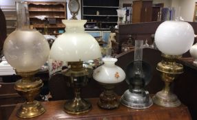 A large collection of brass and other oil lamps.