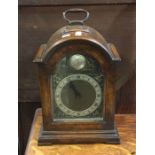 A small mahogany cased mantle clock with silvered