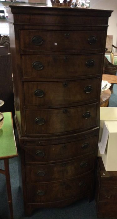 A reproduction seven drawer chest on chest.