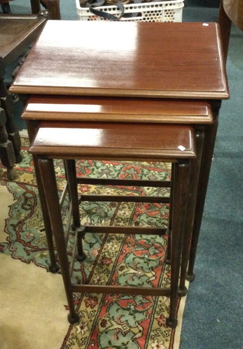 A mahogany nest of tables.