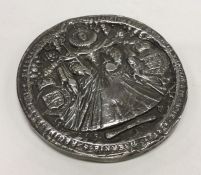 A heavy circular silver plaque depicting Elizabeth