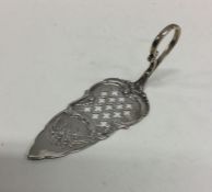 A heavy Continental silver slice with floral decor