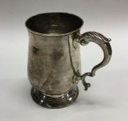 A Georgian silver baluster shaped mug on spreading