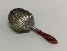 A Georgian silver caddy scoop with agate handle. B