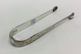 A pair of unusually engraved George III silver sug