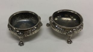A pair of heavy silver salts chased with flowers a