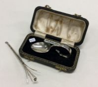 A cased silver spoon together with a silver swizzl