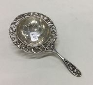 A good Continental silver embossed tea strainer. A