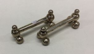 A pair of heavy silver knife rests. By James Dixon