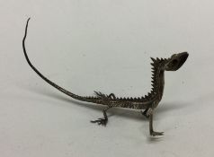 A silver model of a reptile Approx. 10 grams. Est.