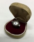 An unusual cased silver ring in the form of a cloc