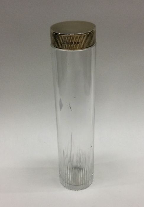 A large silver gilt and glass bottle. London 1938.