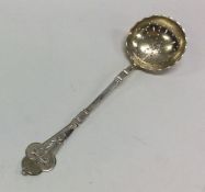 A silver engraved sifter spoon with gilt bowl. App