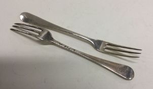 A heavy matched pair of Georgian silver three pron
