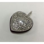 An English silver chased heart pin cushion. Approx