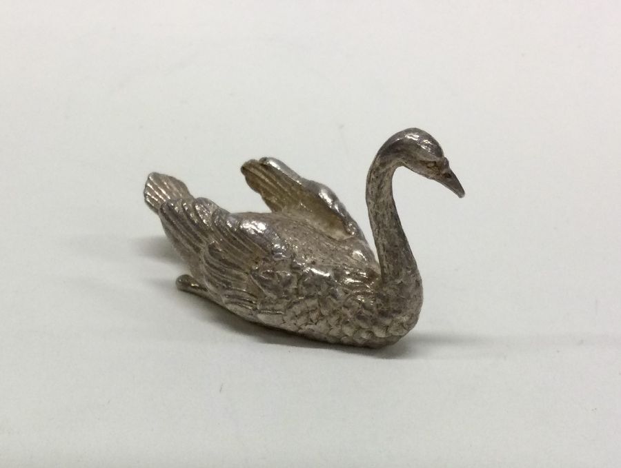A heavy cast figure of a swan with textured body.