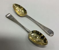 A pair of heavy Georgian silver berry spoons with