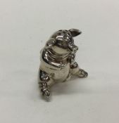 A heavy cast silver pepper in the form of a pig. A