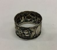 A pair of chased silver napkin rings decorated wit