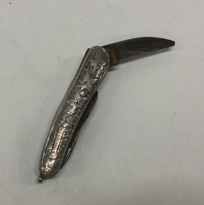 A small engraved silver flick knife. Approx. 19 gr
