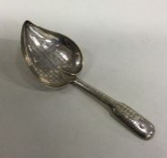 A silver leaf shaped caddy spoon with basket weave