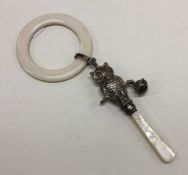 A silver and mother of pearl baby rattle mounted w