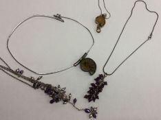 A group of four silver mounted necklaces. Approx.