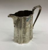 A good Victorian shaped silver cream jug with flor