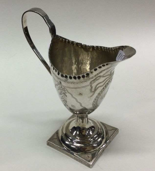 A George III silver cream jug with floral decorati - Image 2 of 2