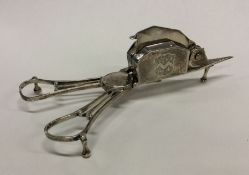 A good pair of Georgian silver candle snuffers wit