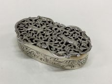 A heavy pierced silver pot pourri decorated with a