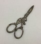 A novelty pair of silver grape scissors in the for