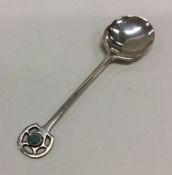 A E JONES: A silver and enamel spoon. Birmingham 1