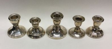 A mixed lot of five silver candlesticks. Birmingha