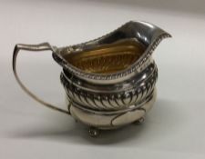 A Georgian silver helmet shaped cream jug. London.
