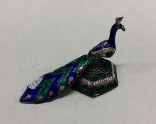 A silver and enamel figure of a peacock. Approx. 49 g