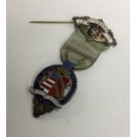 OF ROYAL INTEREST: A silver and enamelled badge. B
