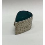 A chased Sterling silver hinged box with stone to