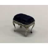 An Edwardian silver pin cushion in the form of a s