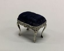 An Edwardian silver pin cushion in the form of a s