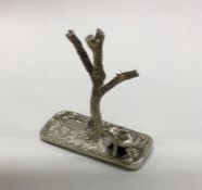 A heavy cast silver ring tree decorated with a rab