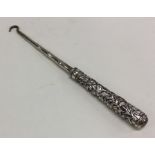 A rare Chinese silver chased hook. Approx. 62 gram