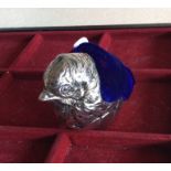 A silver plated pin cushion in the form of a chick