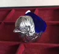 A silver plated pin cushion in the form of a chick