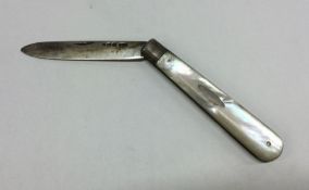 A silver and mother of pearl travelling knife. She
