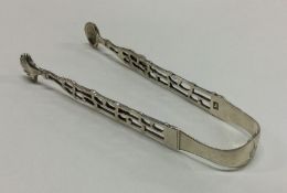 A heavy pair of Georgian cast silver sugar tongs.