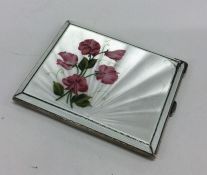 A heavy silver and enamel case with floral decorat