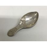 A silver caddy spoon with floral chased handle. Lo