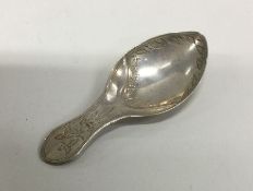 A silver caddy spoon with floral chased handle. Lo