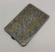 A silver engraved cigarette case with gold inlay d